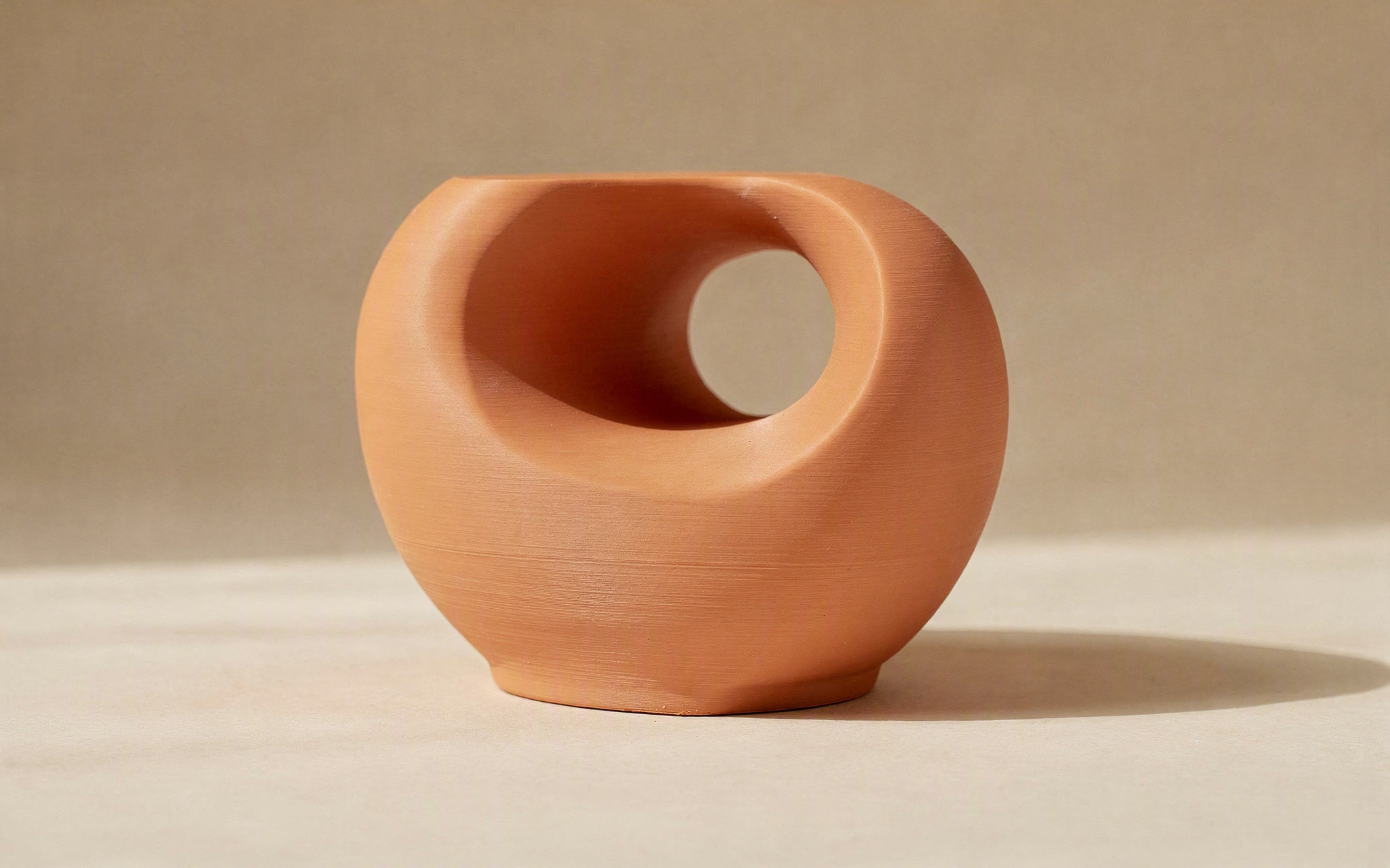 An original pencil design sketch beside the 3D-printed object it produced