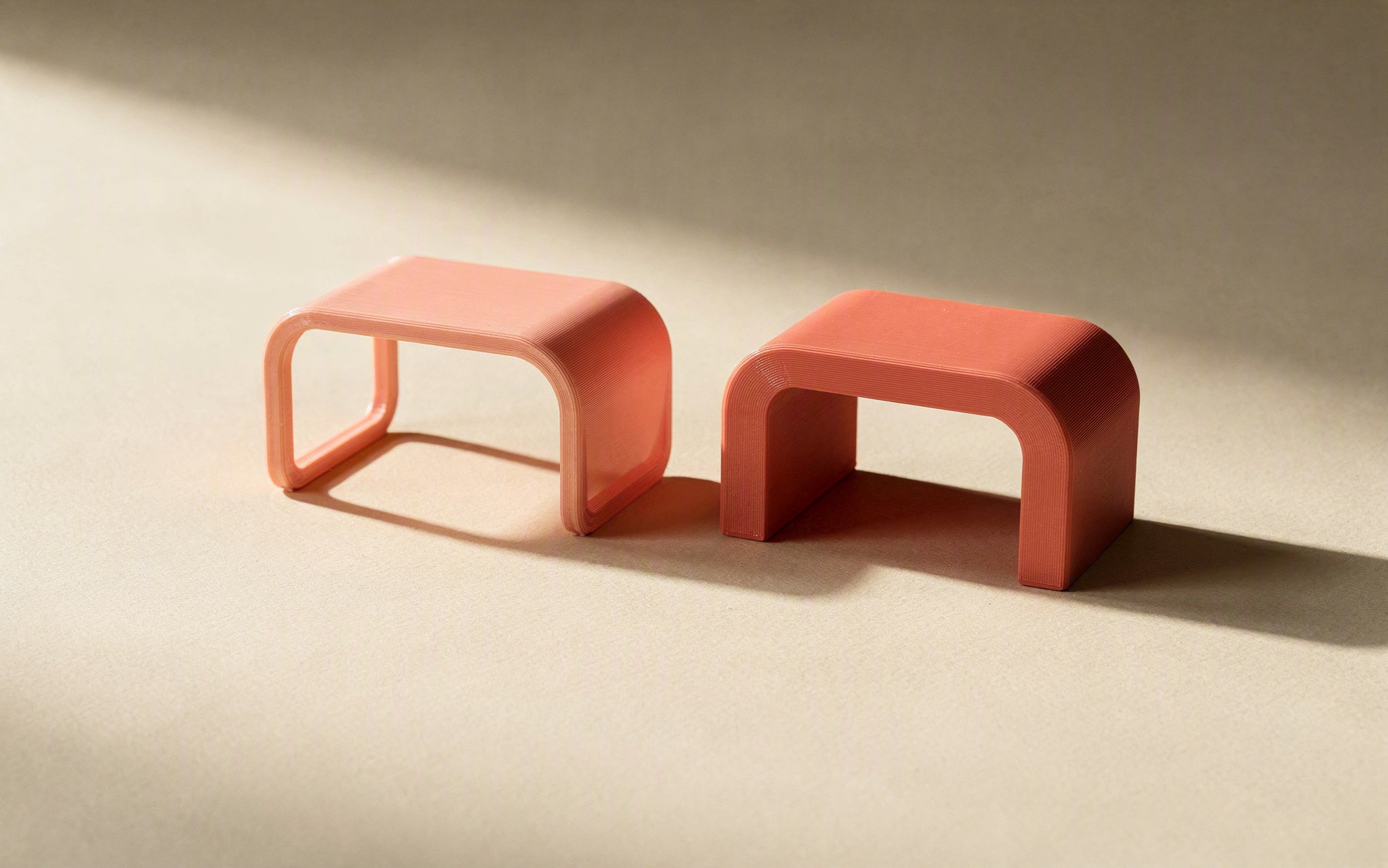 Two identical brackets, one thin and delicate, one thicker and solid